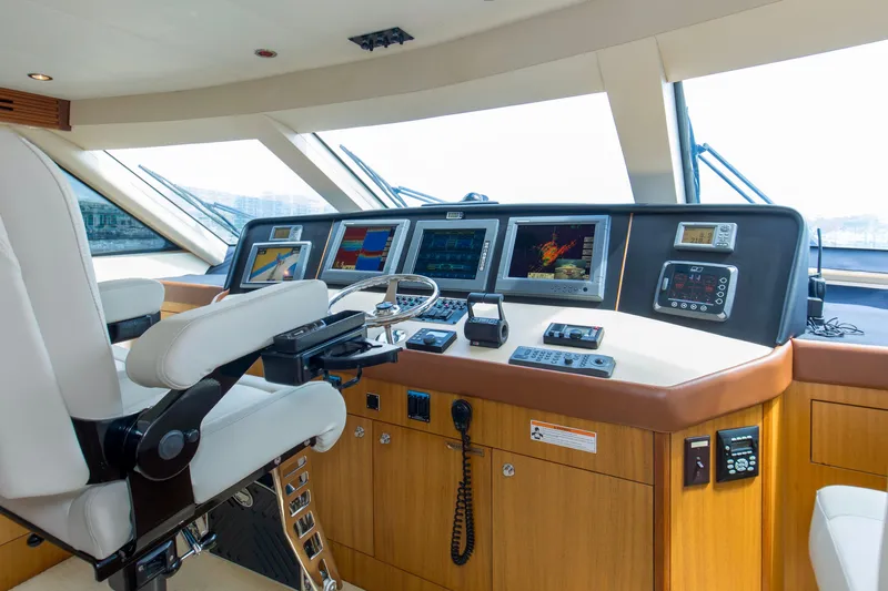 Refuge Yacht Photos Pics 2007 Hatteras 68 Enclosed Bridge yacht helm with advanced navigation systems and luxurious seating.