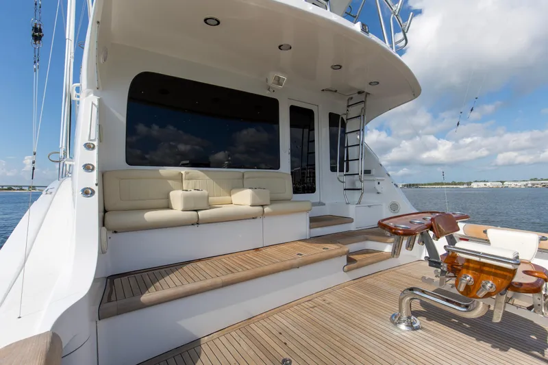 Refuge Yacht Photos Pics 2007 Hatteras 68 Enclosed Bridge yacht deck with seating and fishing chair.