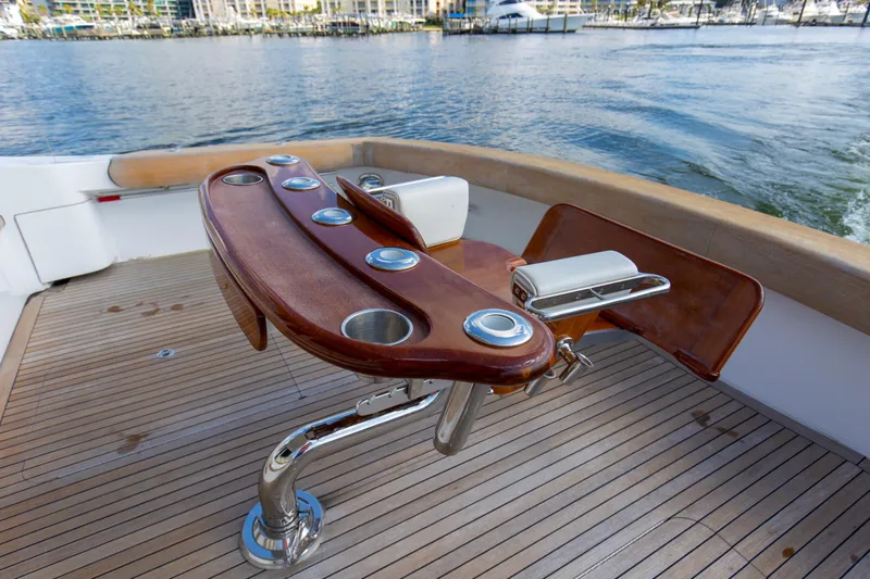 Refuge Yacht Photos Pics Fishing chair on 2007 Hatteras 68 Enclosed Bridge yacht deck, overlooking marina waters.