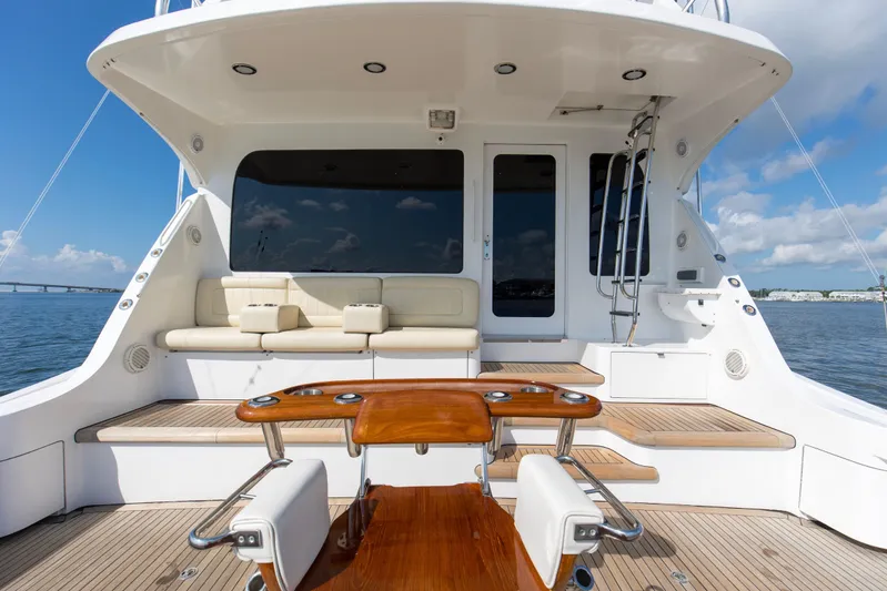 Refuge Yacht Photos Pics Luxurious 2007 Hatteras 68 Enclosed Bridge yacht with spacious deck and seating area.