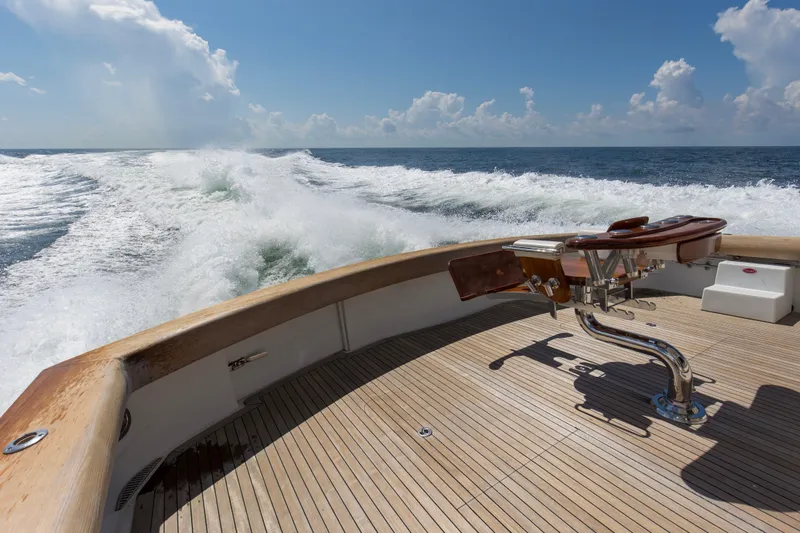 Refuge Yacht Photos Pics 2007 Hatteras 68 Enclosed Bridge yacht cruising on open sea, wooden deck view.