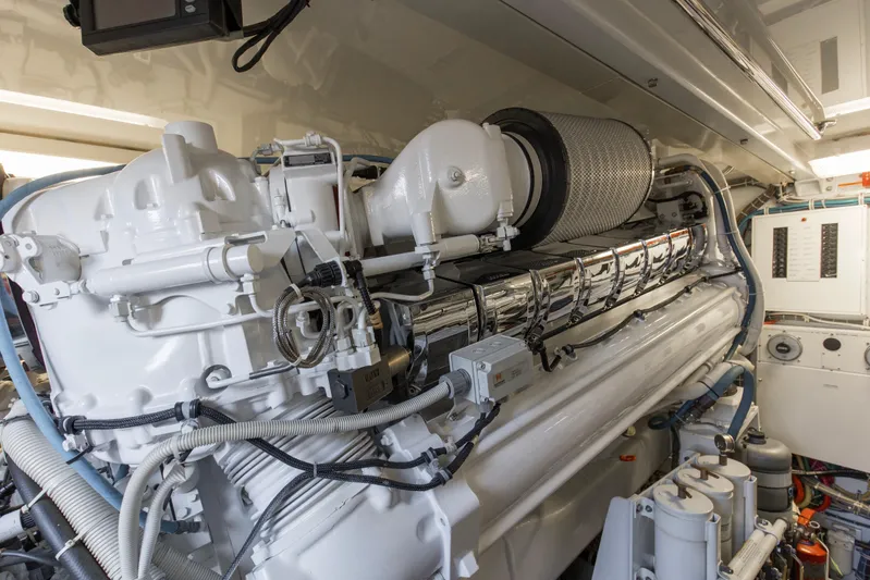 Refuge Yacht Photos Pics Engine room of 2007 Hatteras 68 Enclosed Bridge yacht, showcasing detailed machinery.