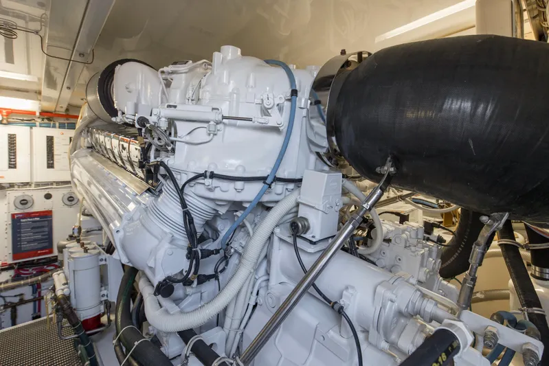 Refuge Yacht Photos Pics Engine room of 2007 Hatteras 68 Enclosed Bridge yacht, showcasing detailed machinery.