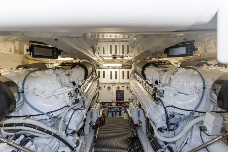 Refuge Yacht Photos Pics Engine room of 2007 Hatteras 68 Enclosed Bridge yacht, featuring dual engines and control panels.