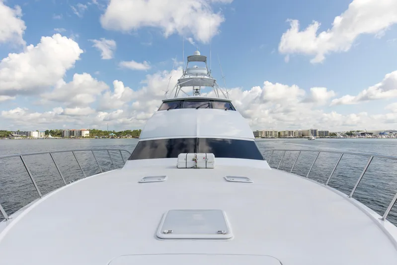Refuge Yacht Photos Pics 2007 Hatteras 68 Enclosed Bridge yacht on calm water under a blue sky.