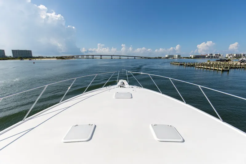 Refuge Yacht Photos Pics Bow view of 2007 Hatteras 68 Enclosed Bridge yacht approaching a scenic bridge.