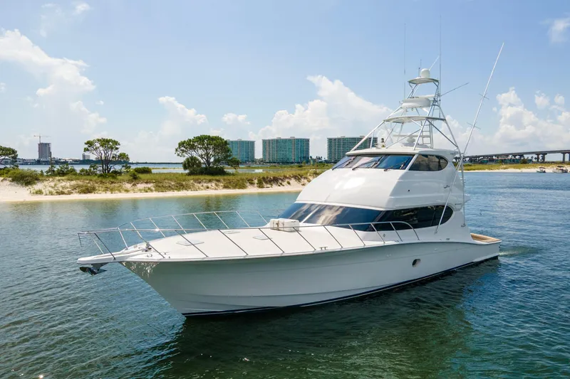 Refuge Yacht Photos Pics 2007 Hatteras 68 Enclosed Bridge yacht cruising near a scenic shoreline.