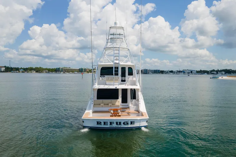 Refuge Yacht Photos Pics 2007 Hatteras 68 Enclosed Bridge yacht on calm water under a cloudy sky.