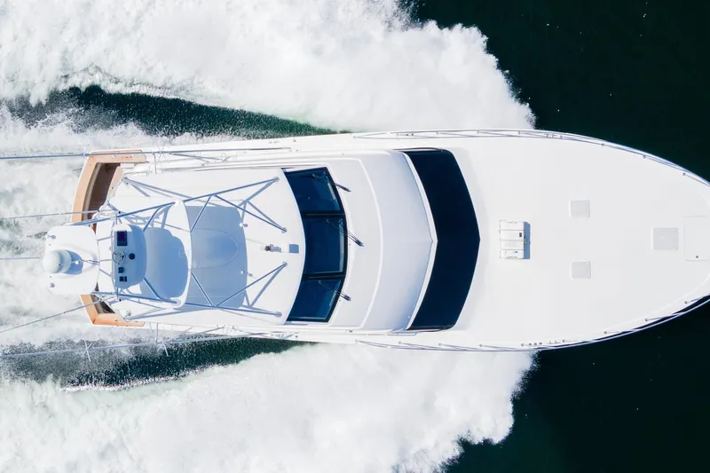 Refuge Yacht Photos Pics Aerial view of 2007 Hatteras 68 Enclosed Bridge yacht cruising on water.