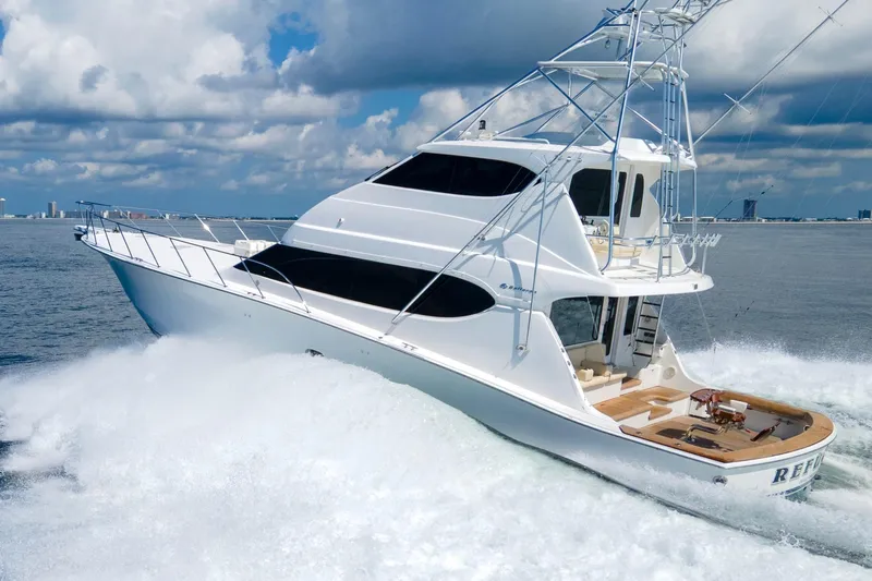 Refuge Yacht Photos Pics 2007 Hatteras 68 Enclosed Bridge yacht cruising on open water under a cloudy sky.