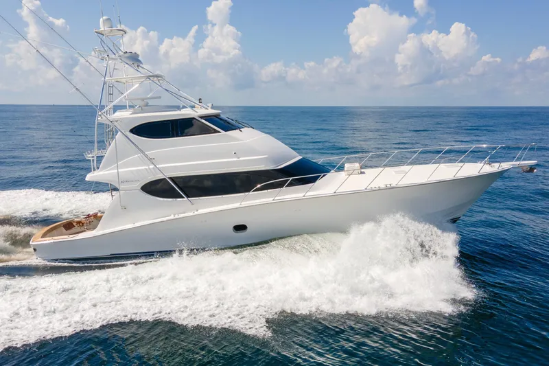 Refuge Yacht Photos Pics 2007 Hatteras 68 Enclosed Bridge yacht cruising on open sea under clear skies.
