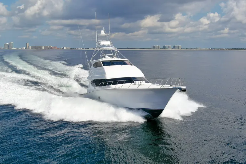 Refuge Yacht Photos Pics 2007 Hatteras 68 Enclosed Bridge yacht cruising on open water under a cloudy sky.