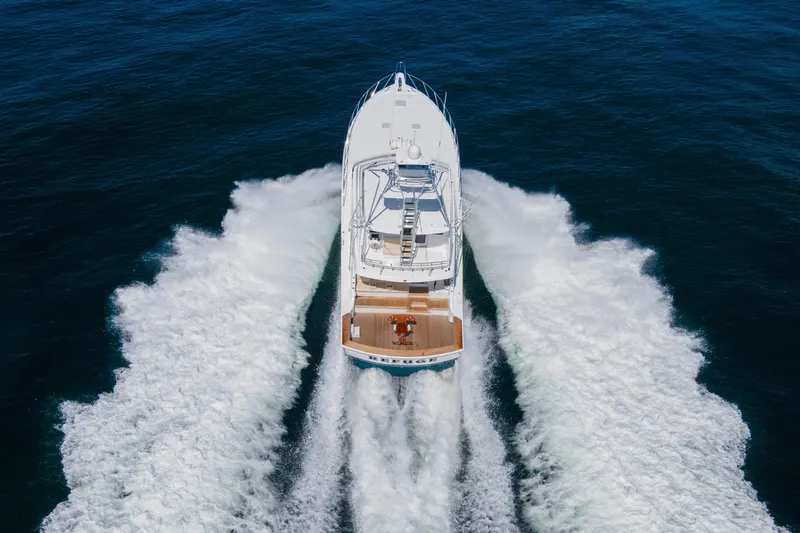 Refuge Yacht Photos Pics 2007 Hatteras 68 Enclosed Bridge yacht cruising on open sea, aerial view.
