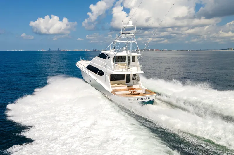 Refuge Yacht Photos Pics 2007 Hatteras 68 Enclosed Bridge yacht cruising on open ocean under blue sky.