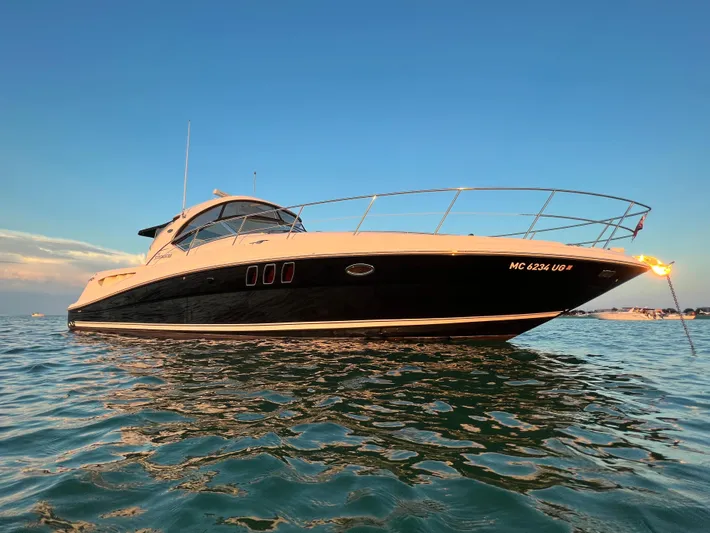 Day Off Yacht Photos Pics 2009 Sea Ray 40 Sundancer yacht on calm water at sunset.