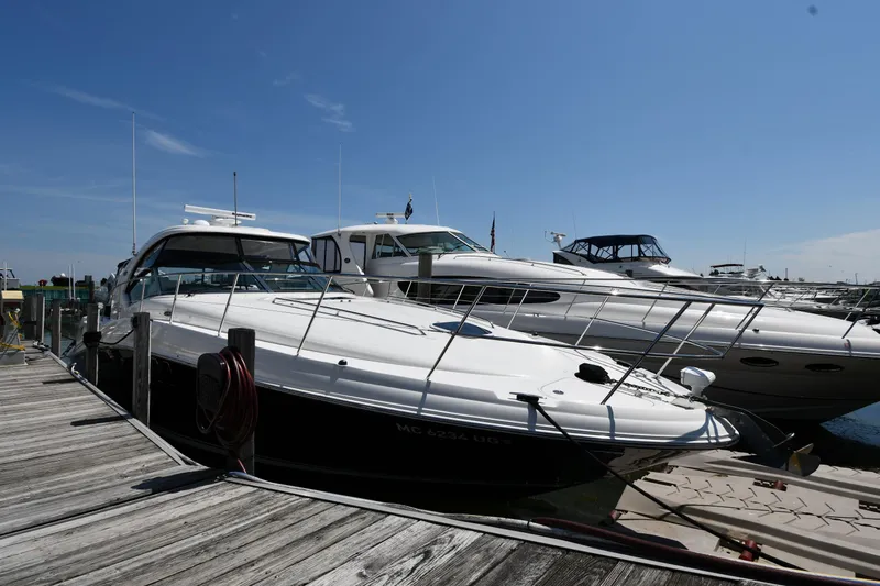 Day Off Yacht Photos Pics 2009 Sea Ray 40 Sundancer yacht docked at marina under clear blue sky.