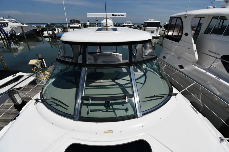 Day Off Yacht Photos Pics 2009 Sea Ray 40 Sundancer yacht docked at marina, surrounded by other boats.
