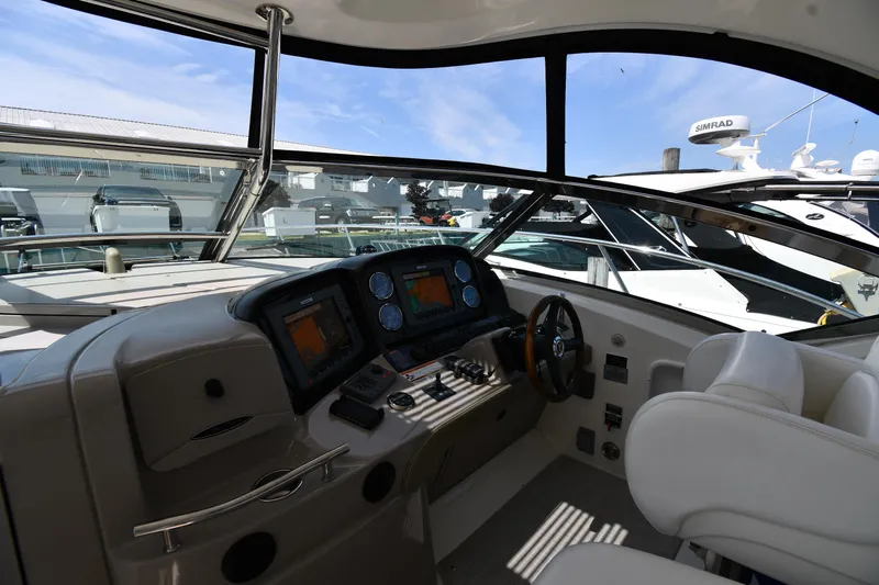 Day Off Yacht Photos Pics Interior view of 2009 Sea Ray 40 Sundancer yacht cockpit with navigation controls.