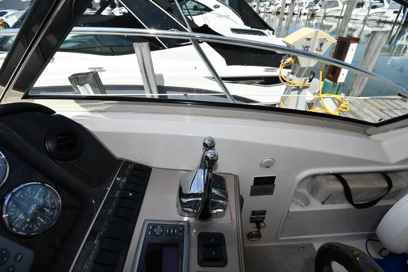Day Off Yacht Photos Pics 2009 Sea Ray 40 Sundancer helm with controls and gauges, docked at marina.