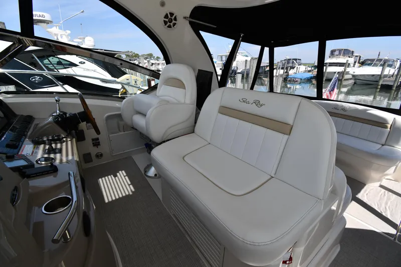 Day Off Yacht Photos Pics 2009 Sea Ray 40 Sundancer interior with white seating and marina view.