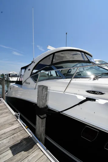 Day Off Yacht Photos Pics 2009 Sea Ray 40 Sundancer yacht docked at marina under clear blue sky.