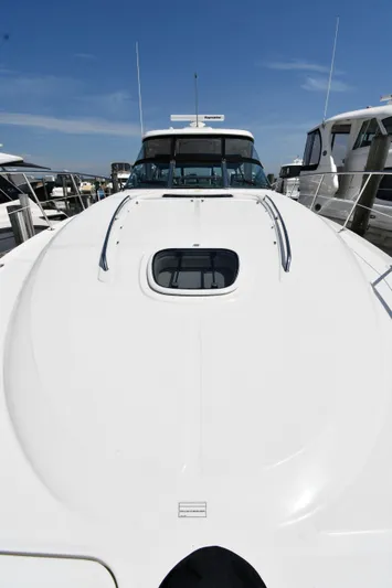 Day Off Yacht Photos Pics 2009 Sea Ray 40 Sundancer yacht with sleek white deck and cabin, docked at marina.