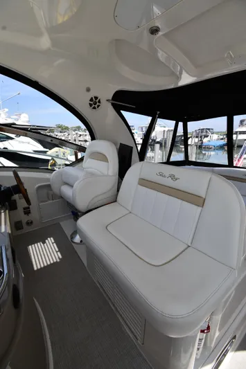Day Off Yacht Photos Pics 2009 Sea Ray 40 Sundancer interior with white seating and marina view.