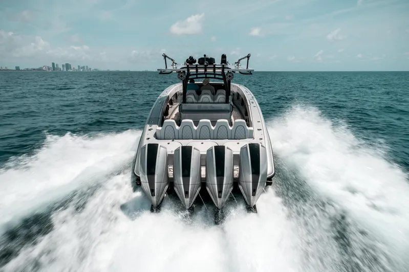  Yacht Photos Pics 2022 Midnight Express 43 Open boat cruising on ocean with city skyline in background.