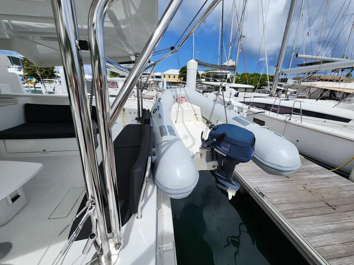 Southern Isle Yacht Photos Pics 2024 Lagoon 46 catamaran with dinghy in harbor.