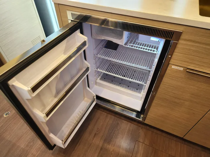 Southern Isle Yacht Photos Pics Open refrigerator in a 2024 Lagoon 46 yacht.