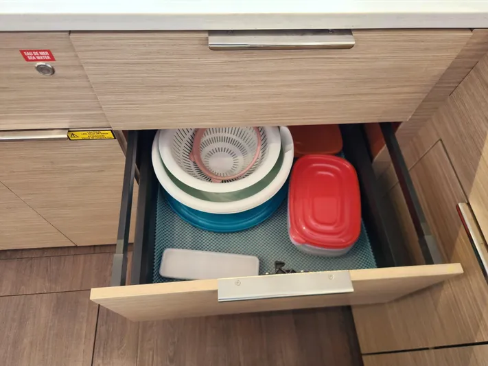 Southern Isle Yacht Photos Pics Open kitchen drawer with bowls and containers on Lagoon 46, 2024 model.