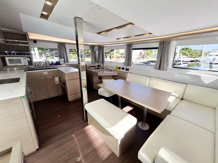 Southern Isle Yacht Photos Pics Interior of 2024 Lagoon 46 yacht with modern kitchen and dining area.