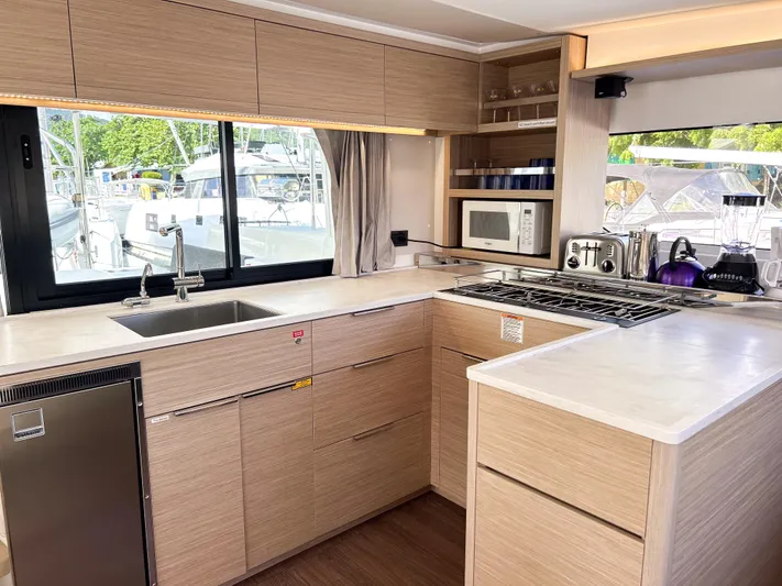 Southern Isle Yacht Photos Pics Modern kitchen in a 2024 Lagoon 46 yacht.