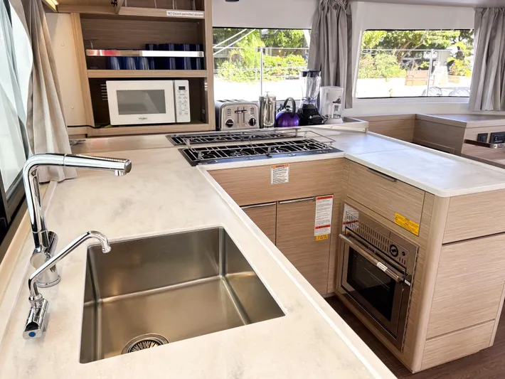 Southern Isle Yacht Photos Pics Modern kitchen in 2024 Lagoon 46 catamaran with appliances.