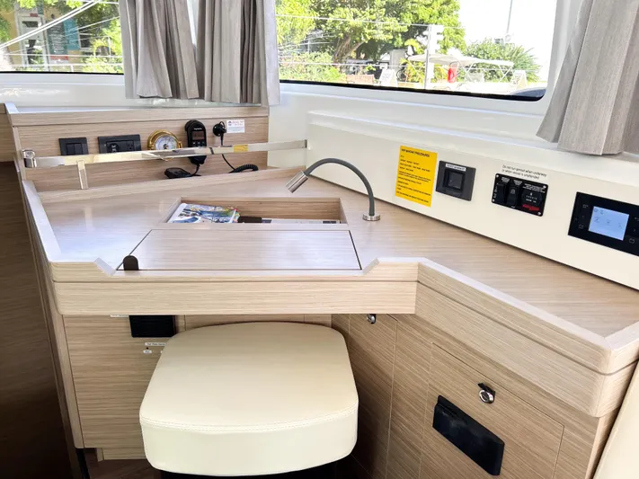 Southern Isle Yacht Photos Pics Interior of 2024 Lagoon 46 yacht with desk and controls.