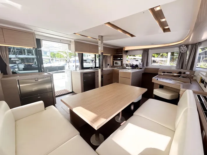Southern Isle Yacht Photos Pics Interior of 2024 Lagoon 46 yacht with modern kitchen and dining area.