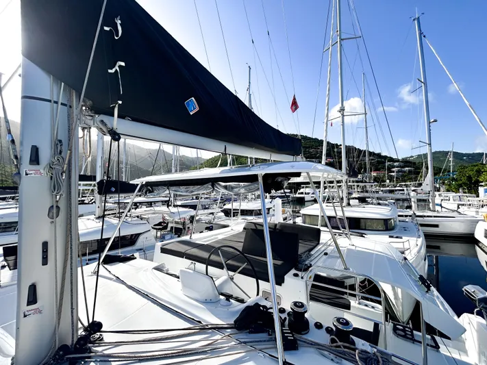 Southern Isle Yacht Photos Pics 2024 Lagoon 46 catamaran docked in marina under sunny skies.