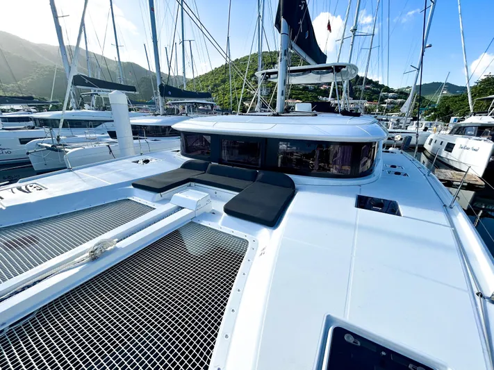 Southern Isle Yacht Photos Pics 2024 Lagoon 46 catamaran docked, sunny day, green hills in background.