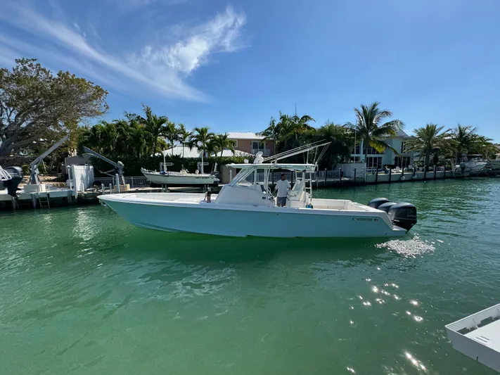  Yacht Photos Pics 2021 Contender 39 Fisharound boat cruising on a sunny, tropical waterway.