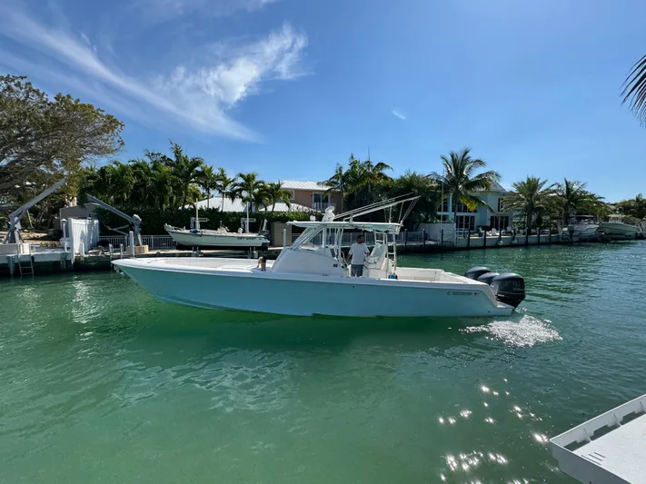  Yacht Photos Pics 2021 Contender 39 Fisharound boat cruising on a sunny, tropical waterway.
