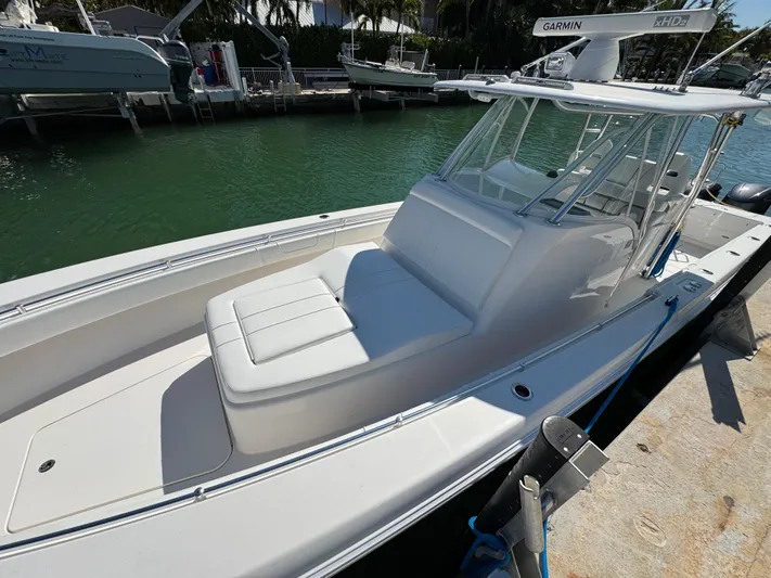  Yacht Photos Pics 2021 Contender 39 Fisharound boat docked, featuring sleek design and spacious seating.