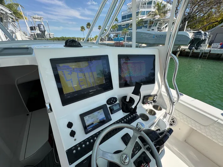  Yacht Photos Pics Cockpit view of 2021 Contender 39 Fisharound with advanced navigation displays and steering wheel.