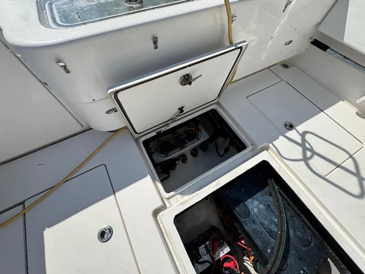  Yacht Photos Pics Contender 39 Fisharound 2021 boat deck with open storage compartments and visible equipment.