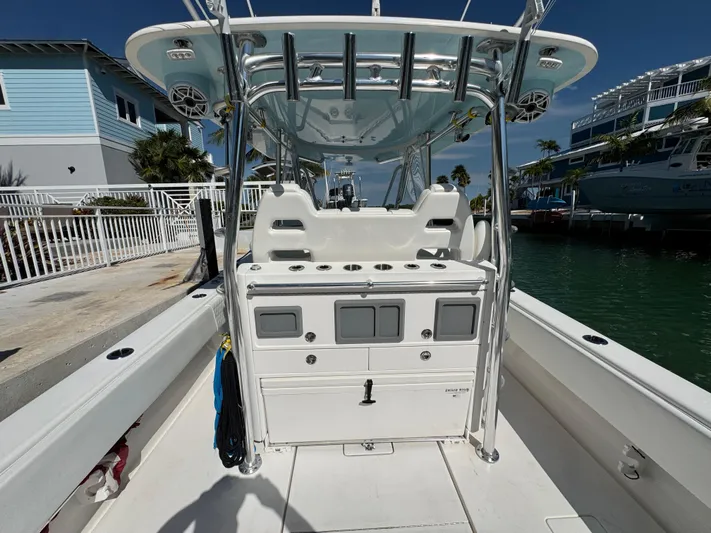  Yacht Photos Pics 2021 Contender 39 Fisharound boat with center console and rod holders, docked by waterfront homes.