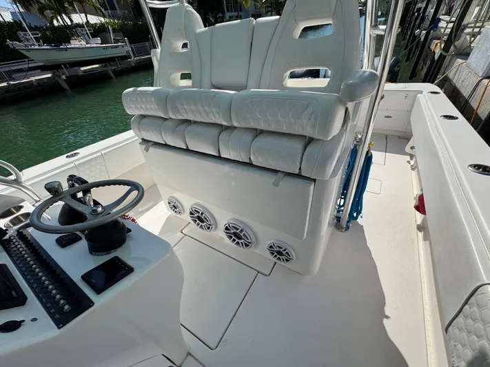  Yacht Photos Pics 2021 Contender 39 Fisharound boat interior with white seating and steering console.