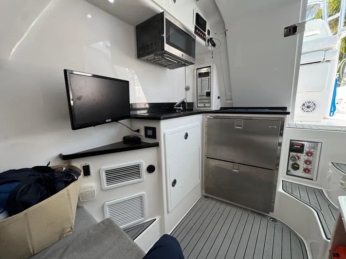  Yacht Photos Pics 2021 Contender 39 Fisharound interior with modern kitchen appliances and sleek design.