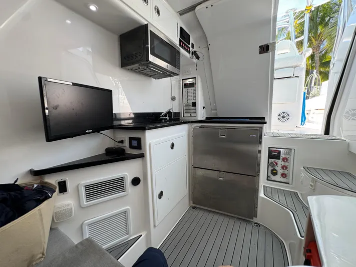  Yacht Photos Pics 2021 Contender 39 Fisharound interior with modern kitchen appliances and sleek design.