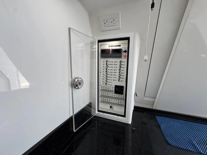  Yacht Photos Pics Electrical panel inside 2021 Contender 39 Fisharound boat, featuring circuit breakers and control switches.