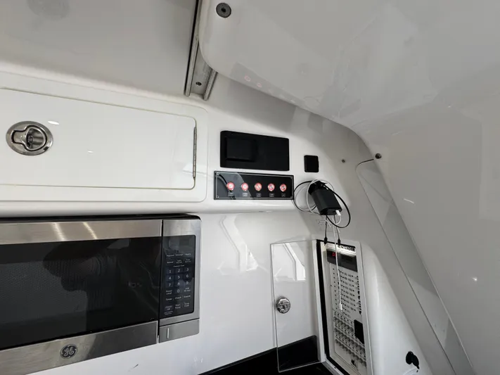  Yacht Photos Pics Interior view of 2021 Contender 39 Fisharound boat with microwave and control panel.