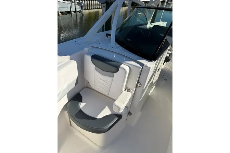E Komo Mai Yacht Photos Pics 2021 Robalo R317 Dual Console boat interior with cushioned seating and windshield.